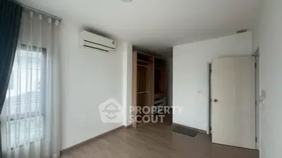 Spacious bedroom with built-in wardrobe and air conditioning in modern apartment