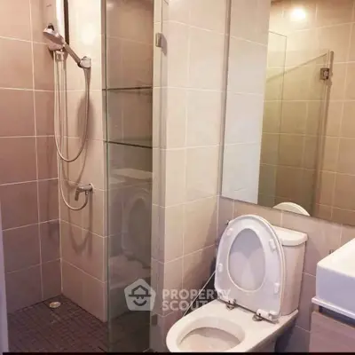 Modern bathroom with glass shower and sleek fixtures in a contemporary apartment.