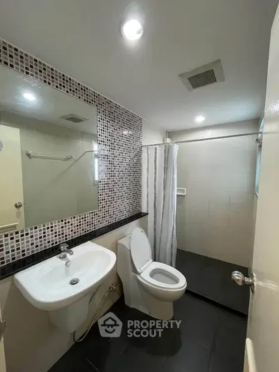 Modern bathroom with sleek fixtures and stylish tile accents in a contemporary home.