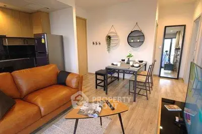 Modern living room with stylish decor and open dining area in cozy apartment.
