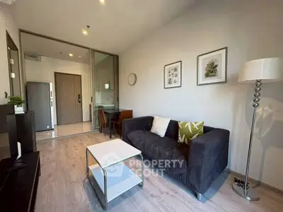 Modern living room with stylish decor and cozy seating in a contemporary apartment.