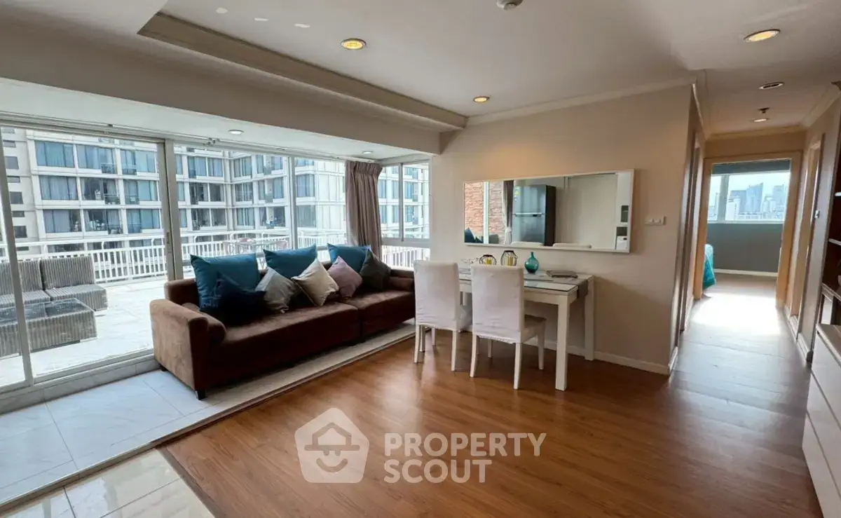 Spacious living room with large balcony and city view in modern apartment