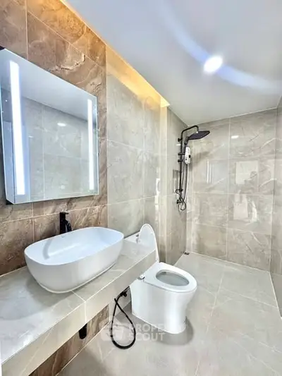 Luxurious modern bathroom with elegant fixtures and spacious shower area.