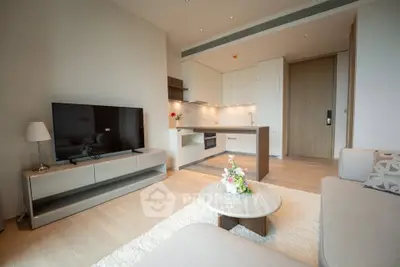 Modern open-layout living room with sleek kitchen and stylish decor