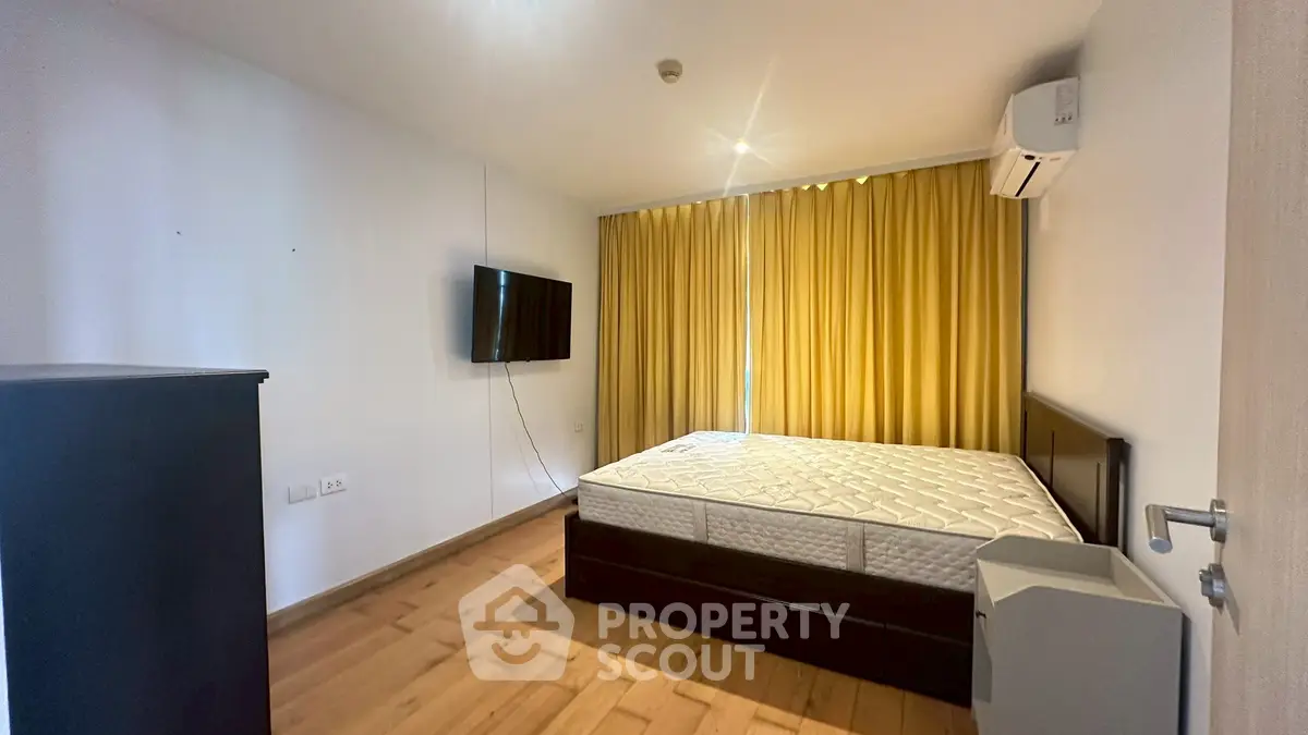 Spacious bedroom with modern furnishings and natural light