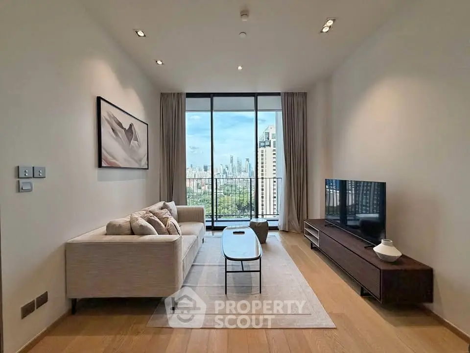 Modern living room with city view, featuring sleek furniture and floor-to-ceiling windows.
