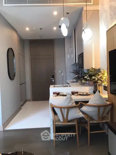 Modern kitchen with sleek design, featuring a breakfast bar and stylish lighting, perfect for urban living.
