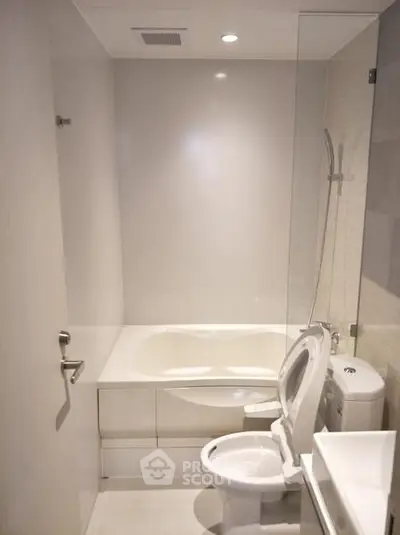 Modern bathroom with sleek design and bathtub in a contemporary apartment.