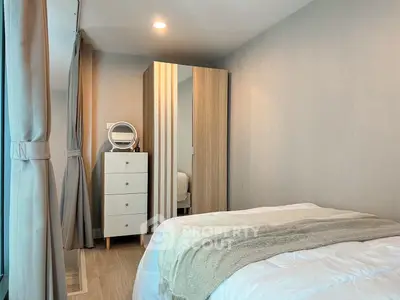 Cozy bedroom with modern decor and ample natural light