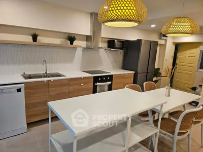 Modern kitchen with sleek appliances and stylish lighting, perfect for culinary enthusiasts.