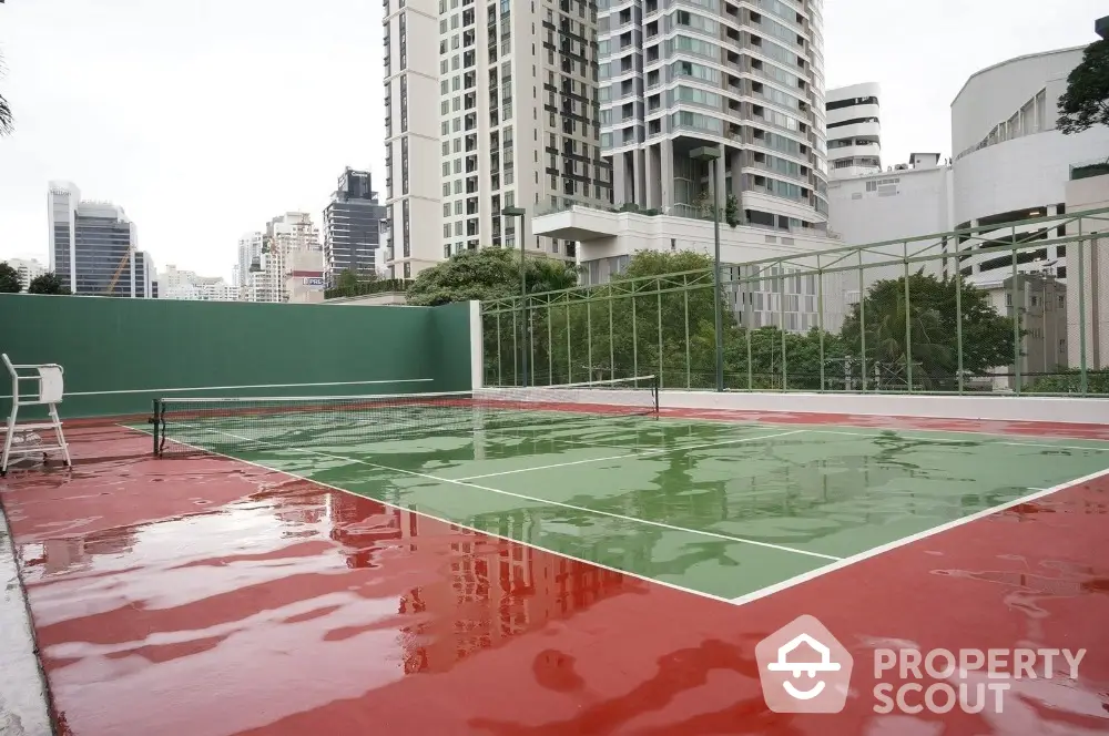 Luxurious high-rise apartment complex with tennis court and city views.