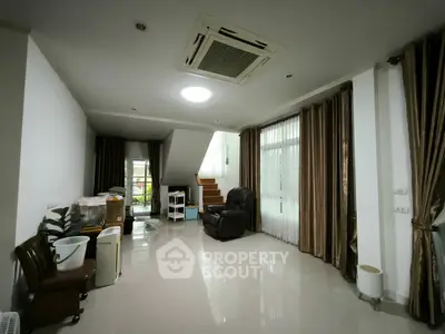 Spacious living room with modern decor and large windows for natural light.