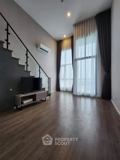 Spacious modern living room with high ceilings and large windows