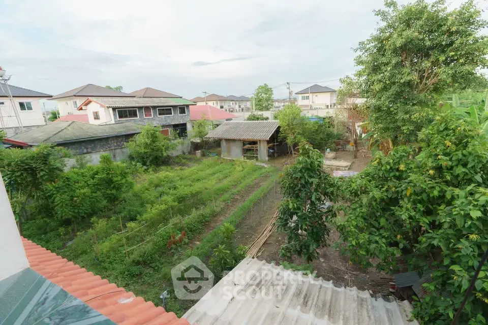 Charming suburban garden view with lush greenery and residential homes, perfect for nature lovers.