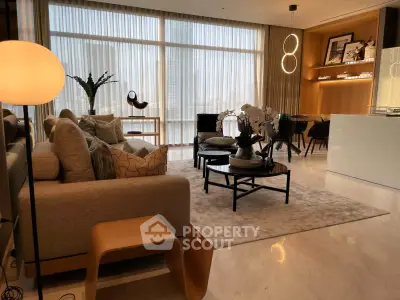 Luxurious modern living room with elegant decor and floor-to-ceiling windows.