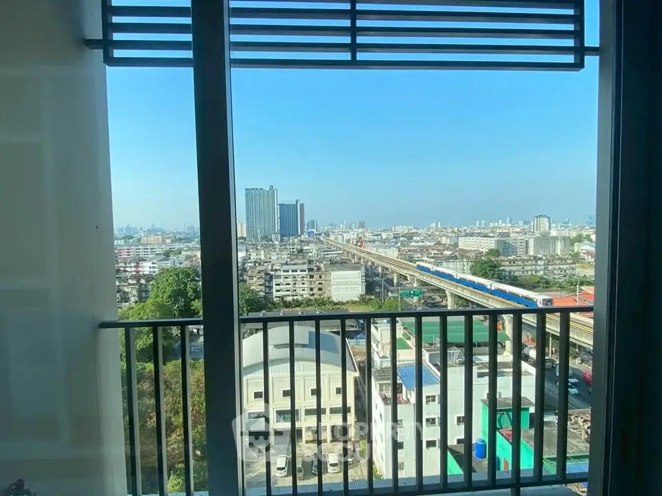 Stunning cityscape view from a high-rise apartment balcony, showcasing urban skyline and railway.