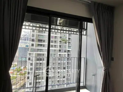Modern apartment balcony with city view and sliding glass doors