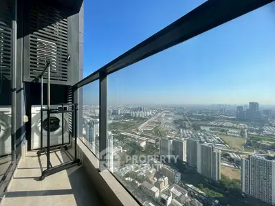Stunning high-rise balcony with panoramic cityscape views and laundry area.