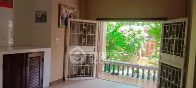 Spacious living room with open doors to lush garden view