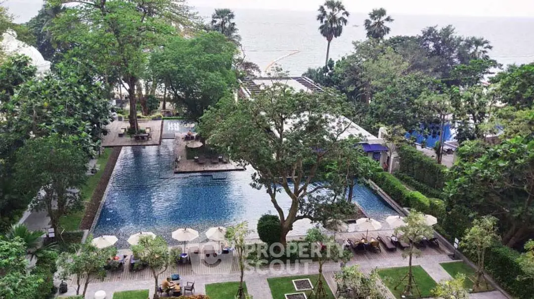 Luxurious oceanfront property with stunning pool and lush gardens, perfect for relaxation and leisure.