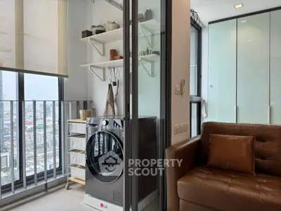 Modern apartment with balcony, washing machine, and stylish living area.