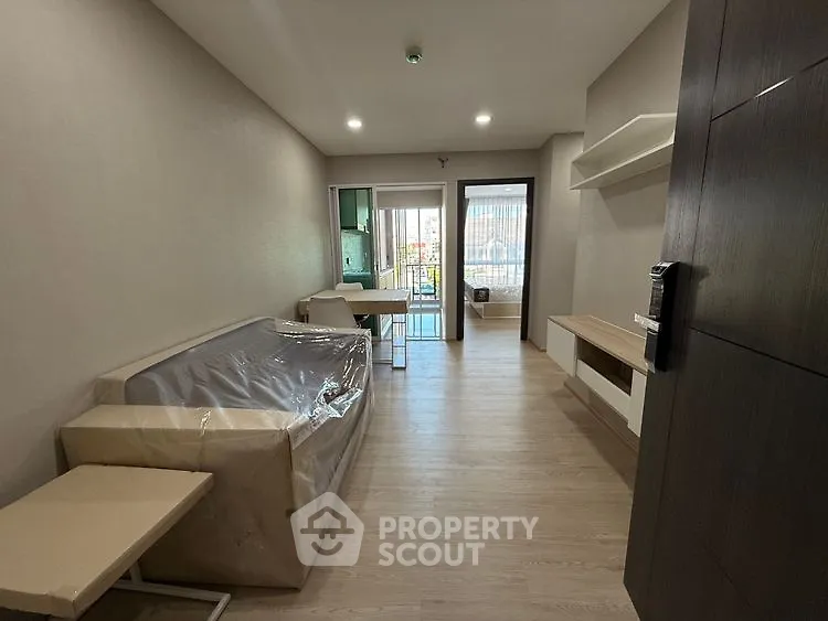 Modern living room with balcony access and sleek furnishings