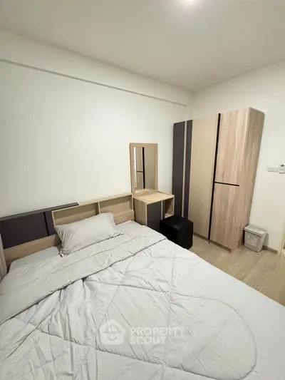 Cozy bedroom with modern furniture and neutral tones, perfect for relaxation.