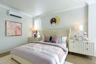 Elegant bedroom with plush bed, stylish decor, and soft lighting