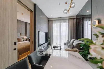 Modern open-plan living room with elegant decor and natural light