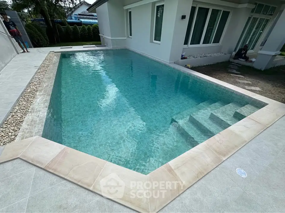 Luxurious private pool in modern residential property with serene surroundings.