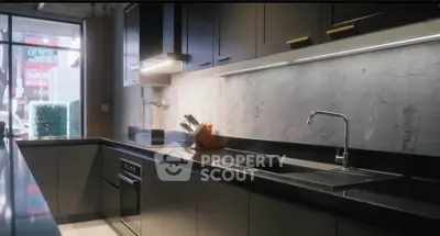 Modern kitchen with sleek black countertops and under-cabinet lighting