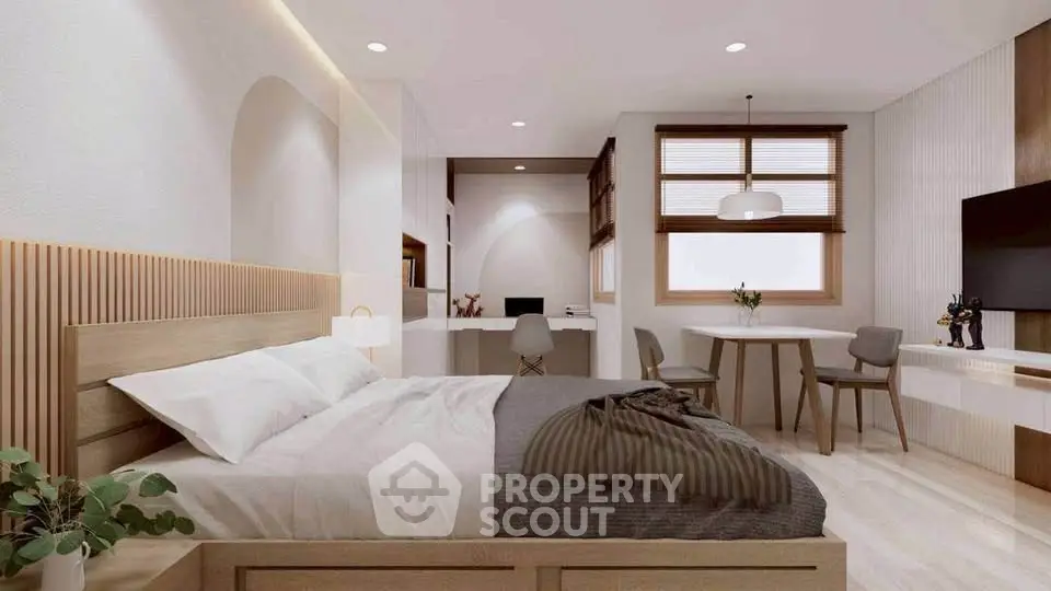 Spacious modern bedroom with elegant decor and cozy seating area, perfect for relaxation and comfort.