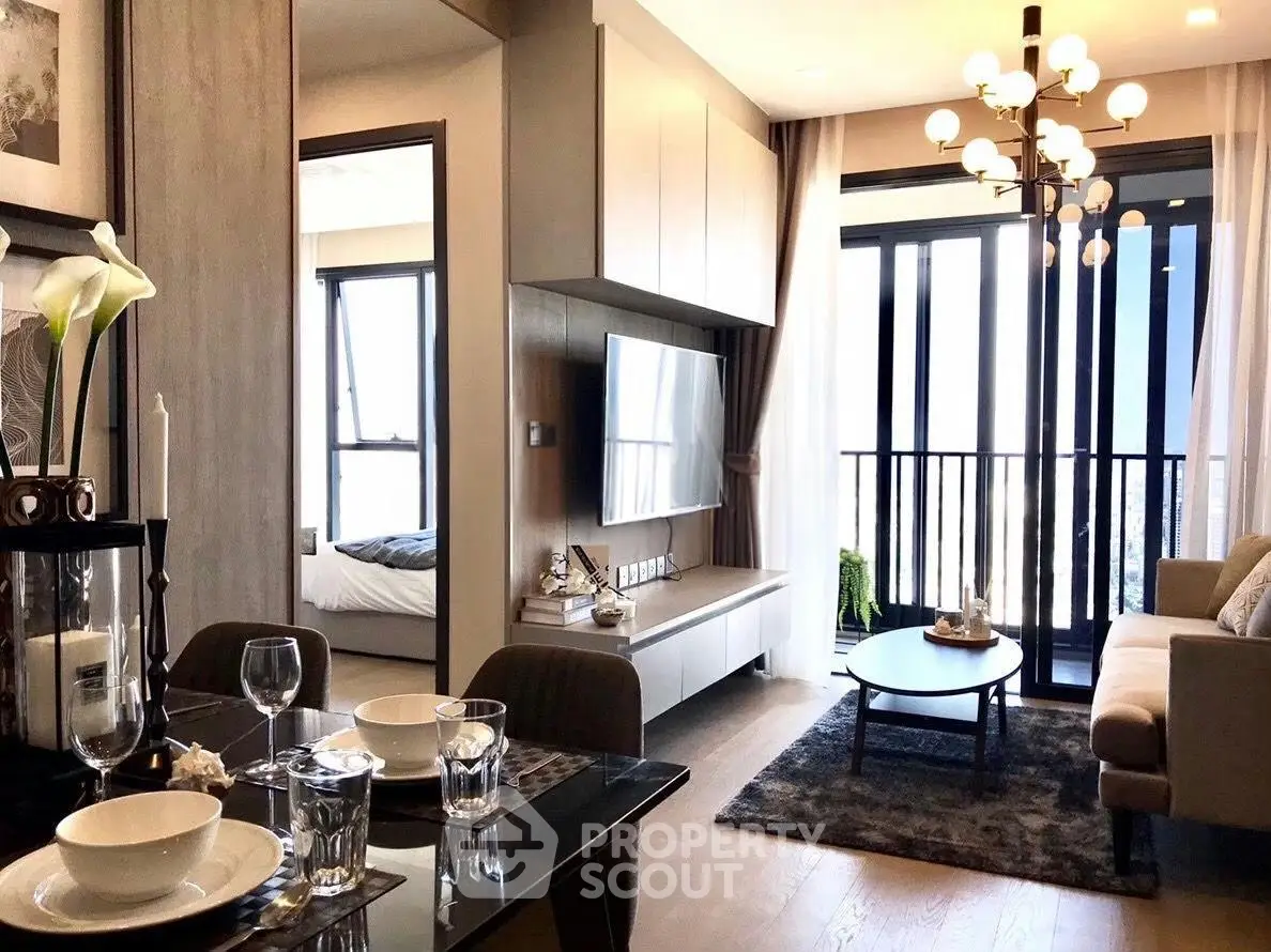 Modern living room with elegant decor and balcony view in a stylish apartment.