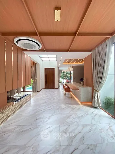 Luxurious modern living room with marble flooring and elegant wooden ceiling design.