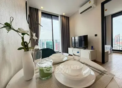 Modern living room with dining setup and city view balcony