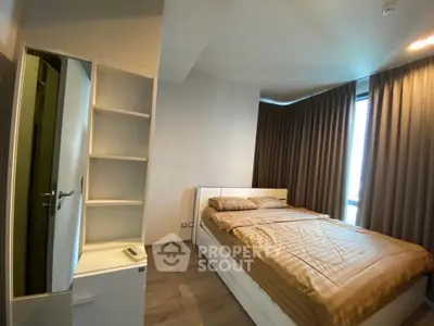 Modern bedroom with cozy bed and stylish curtains in a contemporary apartment.