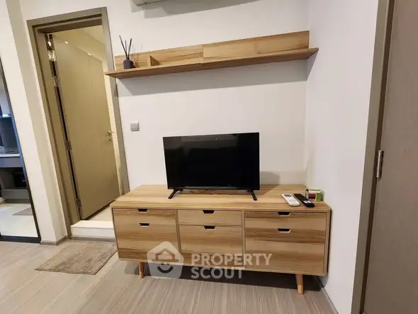 Modern living room with sleek wooden TV stand and minimalist decor