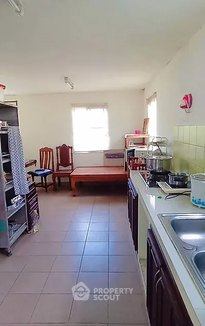 Spacious kitchen with ample natural light and modern fixtures, perfect for culinary enthusiasts.