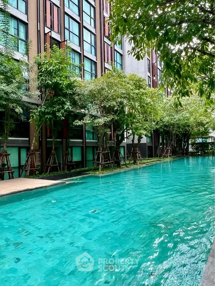 Luxurious condominium with stunning pool and lush greenery for serene living.