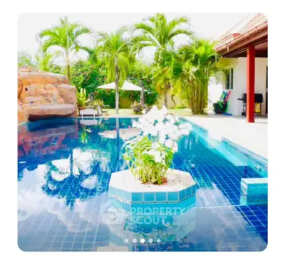Luxurious tropical pool with lush greenery and elegant design