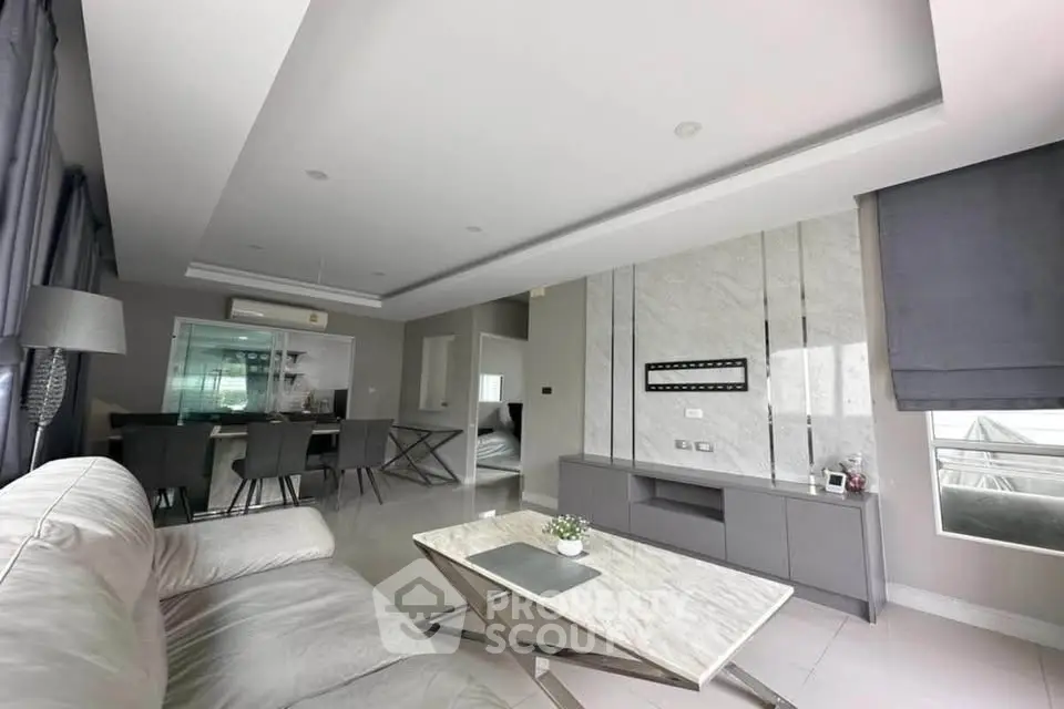 Modern living room with sleek marble accents and stylish furniture