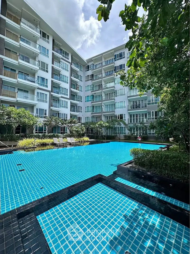 Luxurious condominium with stunning pool view and lush greenery, perfect for modern living.