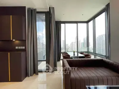 Luxurious modern living room with panoramic city views and elegant furnishings.