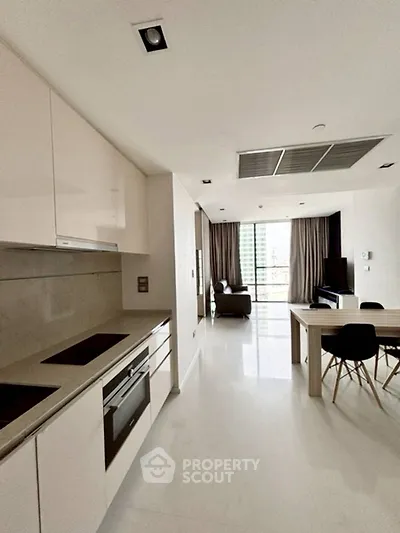 Modern open-plan kitchen and living area with sleek design and natural light.