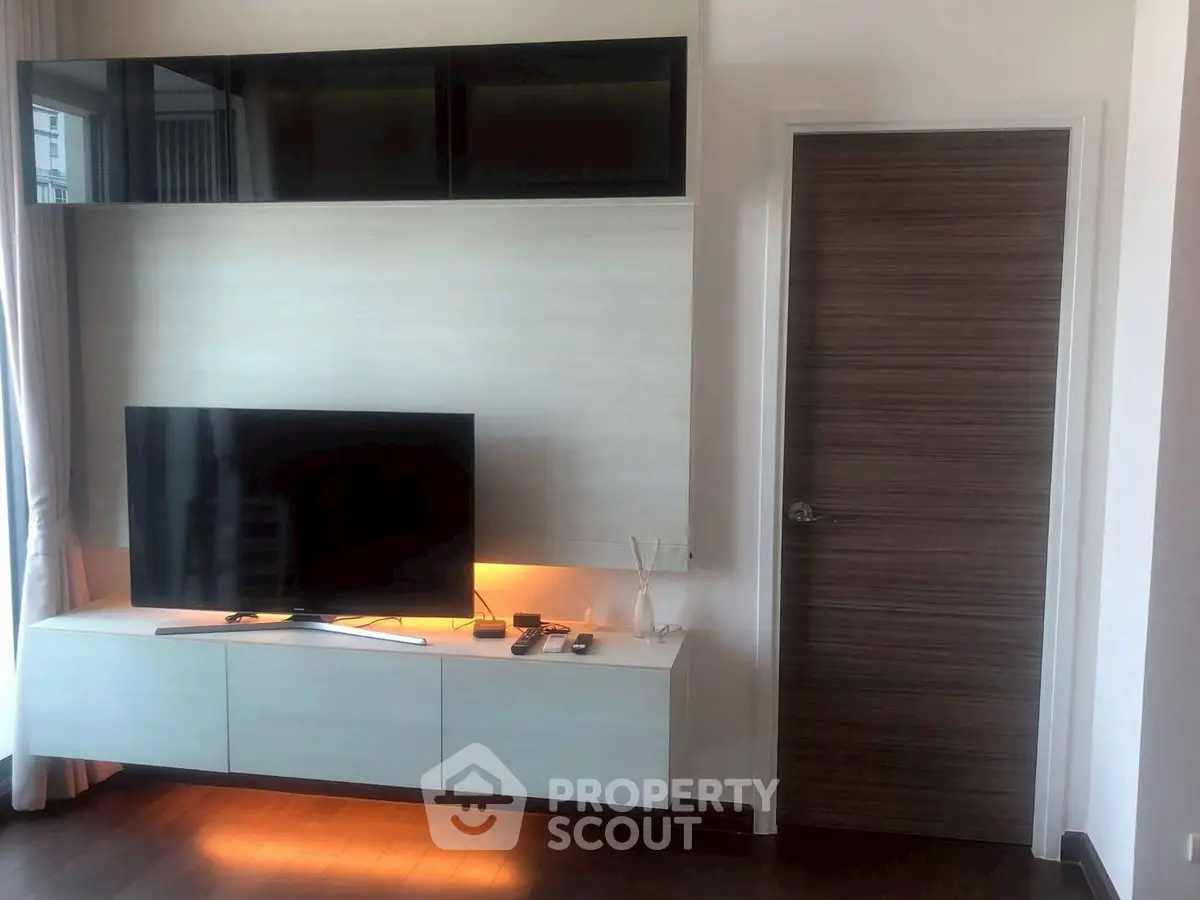 Modern living room with sleek TV setup and stylish wooden flooring