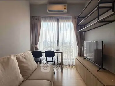 Modern living room with city view, featuring cozy sofa, TV, and dining area by large window.