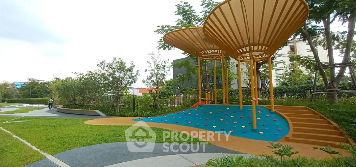 Modern urban park with unique climbing structure and lush greenery