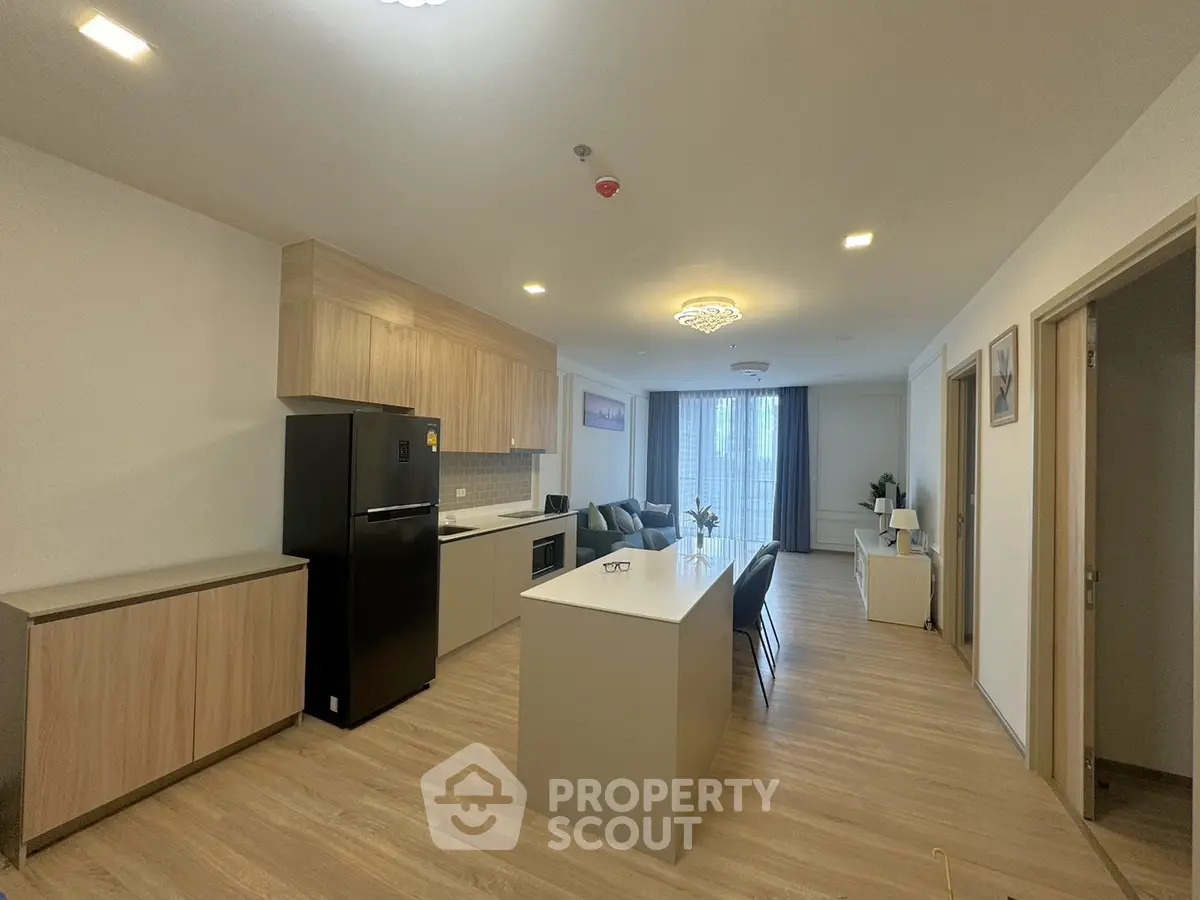 Modern open-plan kitchen and living room with sleek design and natural light.