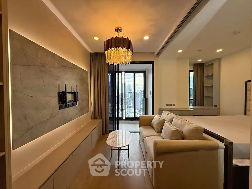 Luxurious living room with elegant chandelier and city view balcony