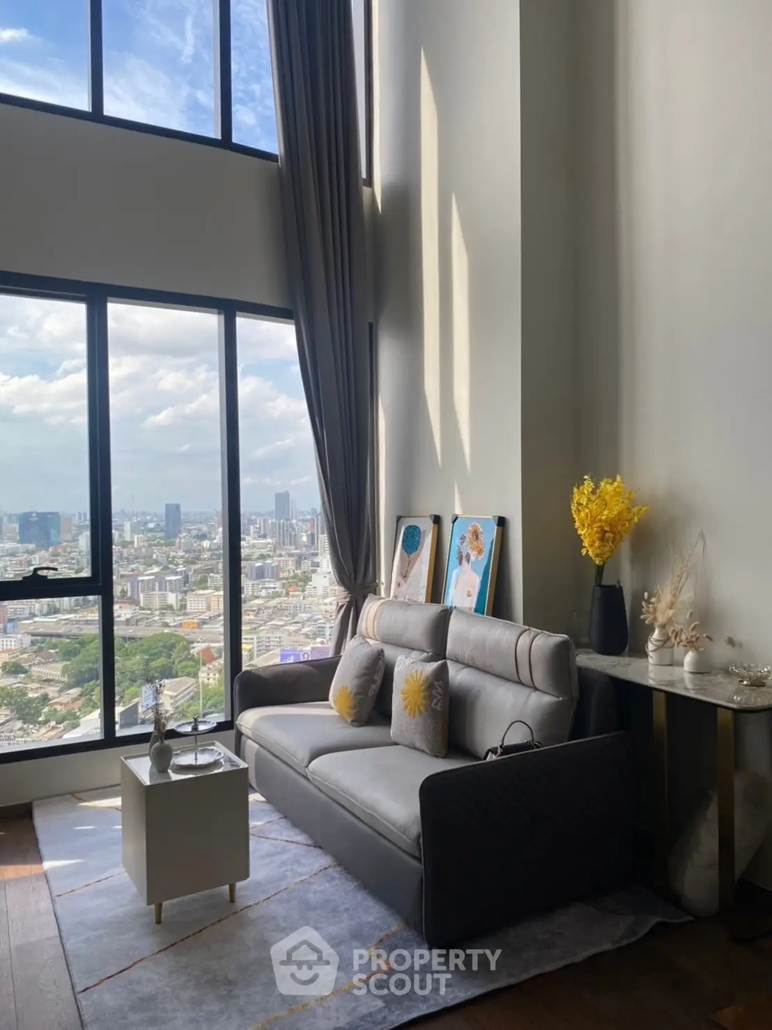 Luxurious high-rise living room with stunning city view and elegant decor.